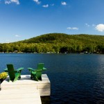 Two chairs on a dock overlooking the water