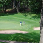 Two golfers on the course in the distance