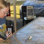 Carolyn Adamczyk creating a stained glass panel